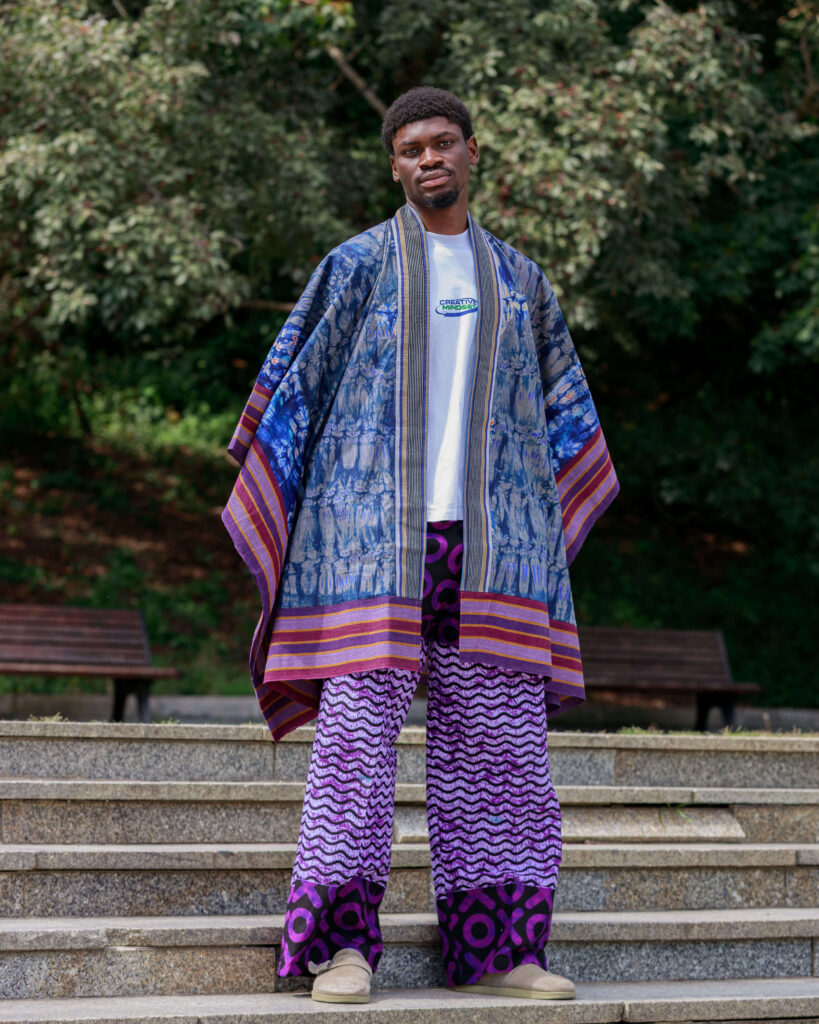 Man wearing a handcrafted men's Adire Agbada with Aso oke trim