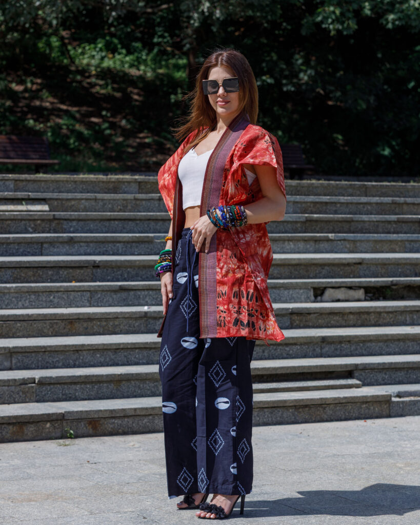 Woman wearing a handcrafted Adire Agbada with Aso oke trim