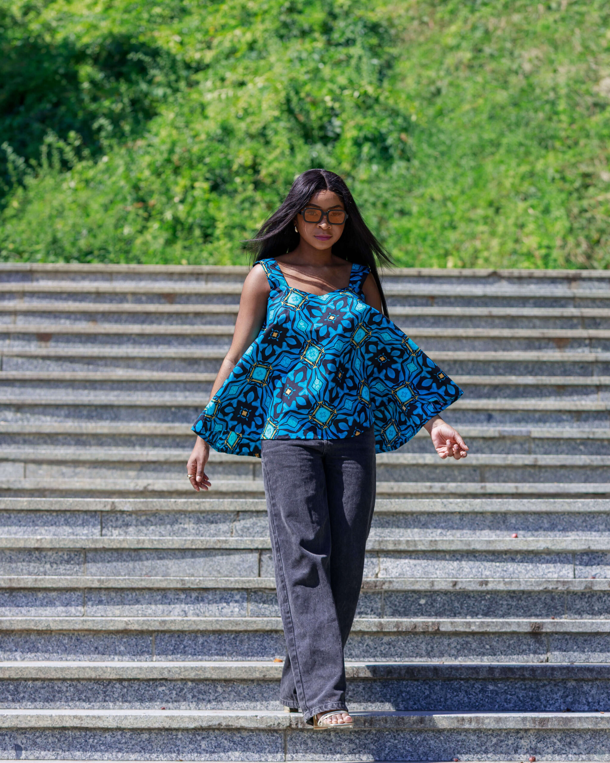 Woman wearing an Ankara flared sleeveless swing top