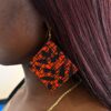 Woman wearing colourful Ankara earrings