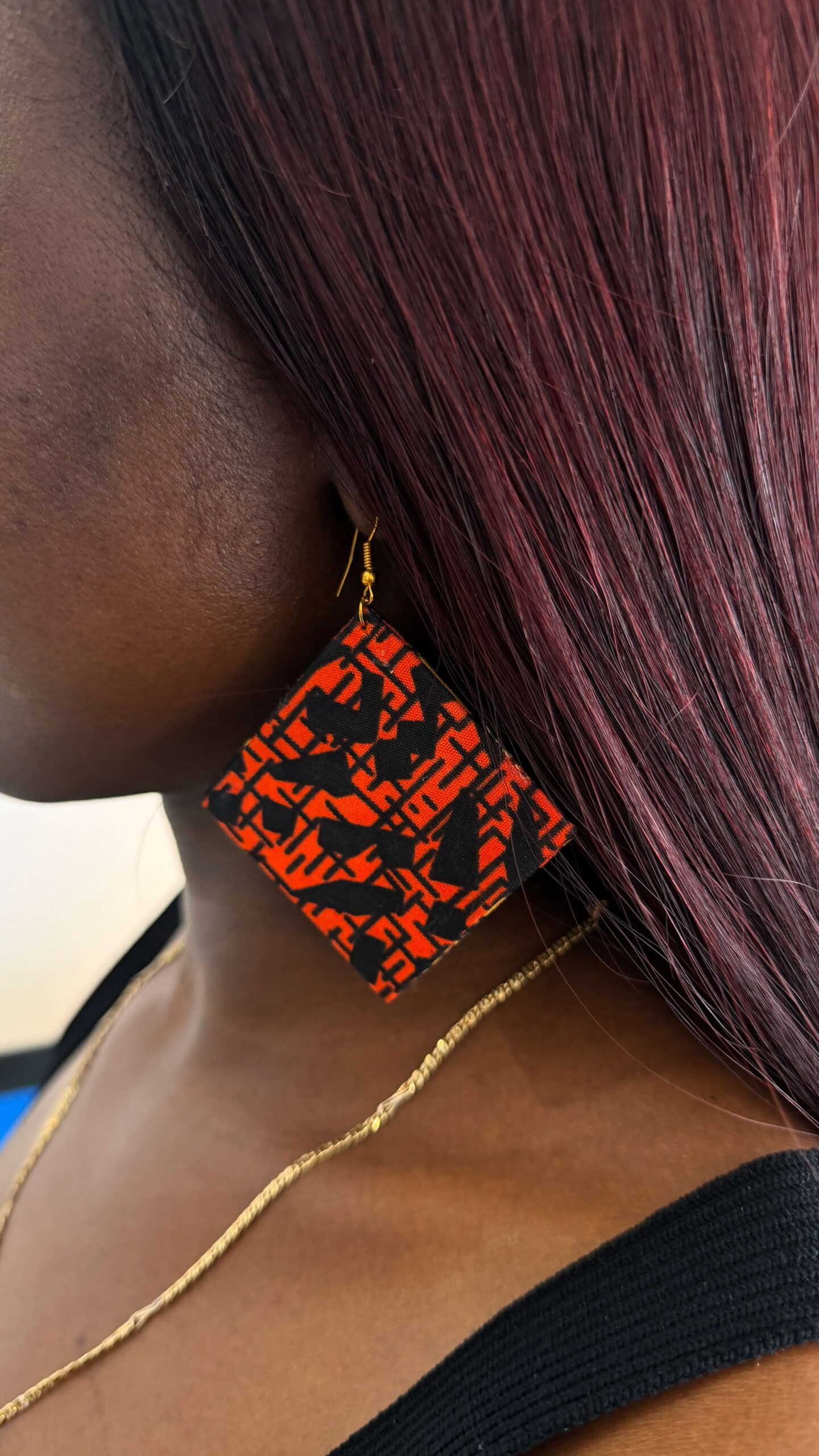Woman wearing colourful Ankara earrings