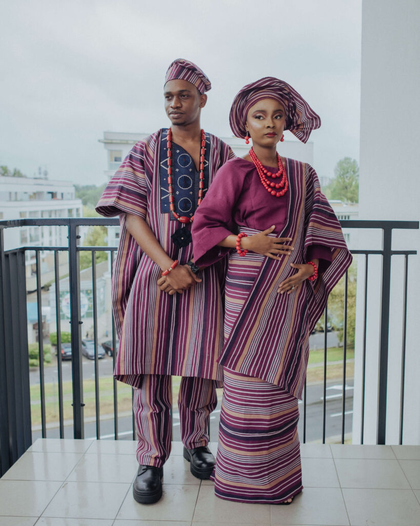 Couple standing full body on balcony with Aso-Oke outfit